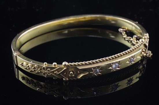 A late Victorian 15ct gold and diamond hinged bangle,